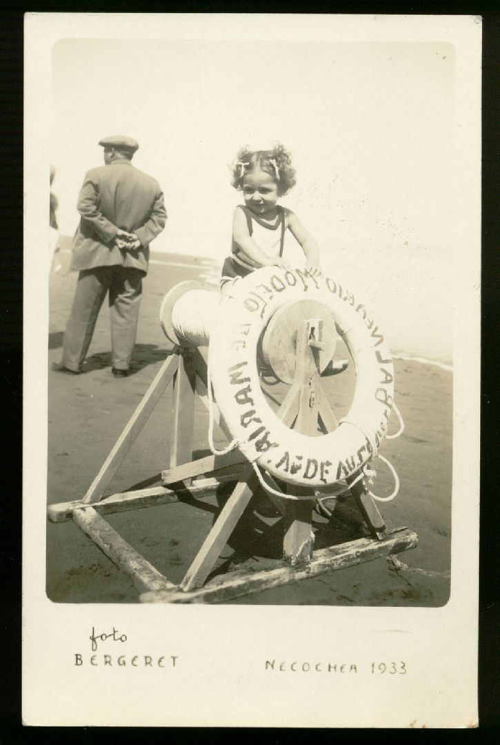 CUTE KID GIRL IN BATHING SUIT ON A LIFESAVER. A genuine Vintage REAL PHOTO